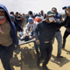 Palestinian medics and protesters evacuate a seriously wounded youth during a deadly protest at the Gaza Strip’s border with Israel, east of Khan Younis, Gaza Strip, on May 14, 2018. Thousands of Palestinians are protesting near Gaza’s border with Israel as Israel celebrates the inauguration of a new U.S. Embassy in contested Jerusalem.